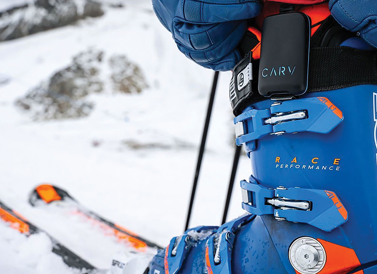 Close up of the Carv battery pack case clipped onto a blue ski boot